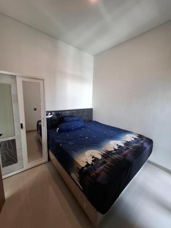 a bedroom with a large bed in a room at Athara Naya in Karangploso