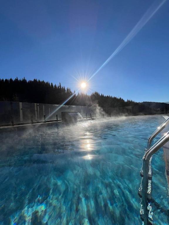 a hot spring with the sun in the background at GirSki in Bukovel