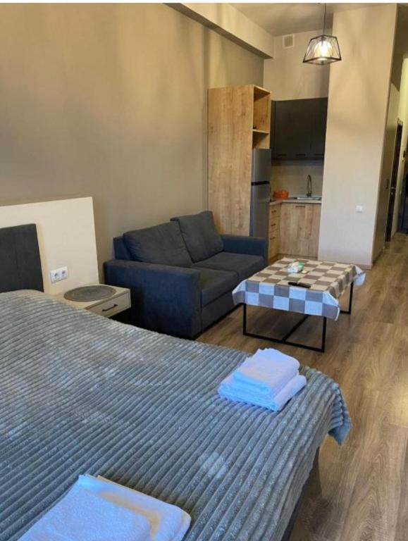 a living room with a bed and a couch at Kechi Dom 6 in Tsaghkadzor