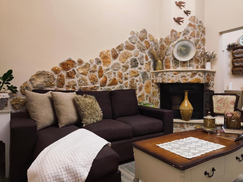a living room with a couch and a fireplace at Vicky's House in Kos