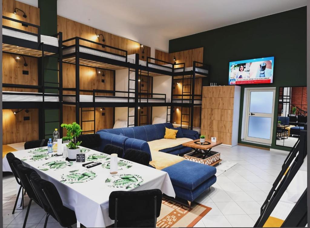 a living room with a table and a couch at City Center Hostel Durres in Durrës