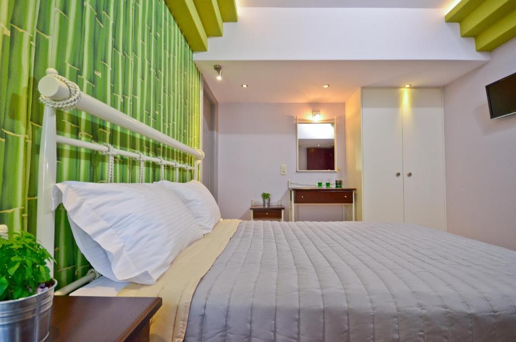 a bedroom with a bed and a green wall at Kavourakia in Agios Prokopios