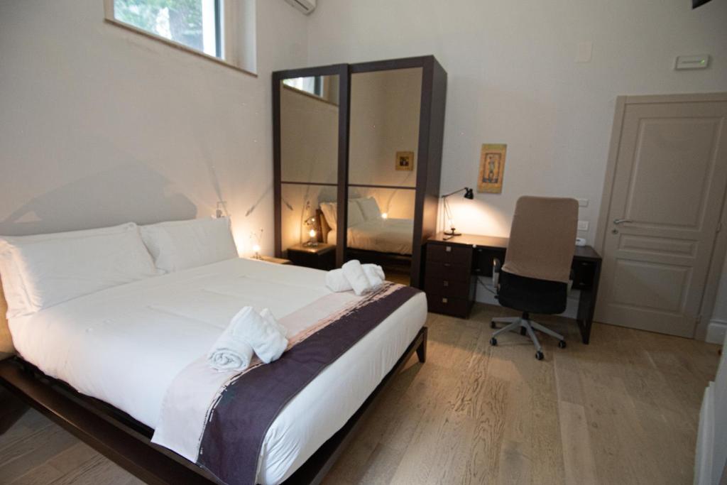 a bedroom with a bed and a desk with a computer at Superior Room - Smart Working - 100m from center in Salerno