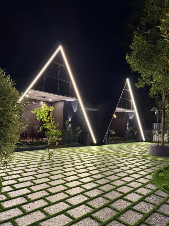 a building with lights in front of it at night at Creek Cottage in Kollam