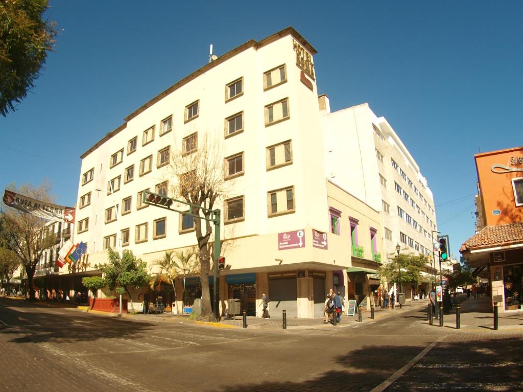 a large white building on a city street at Roma Guadalajara in downtown in Guadalajara
