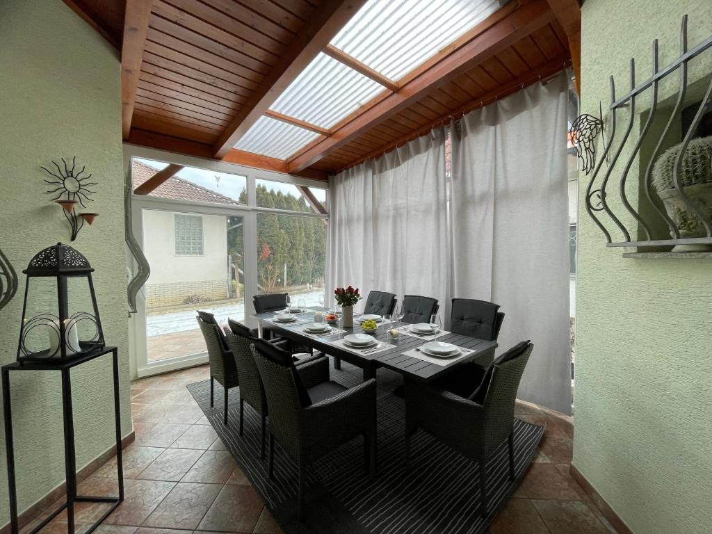 a dining room with a long table and chairs at Ferienhaus Engel in Fertőhomok