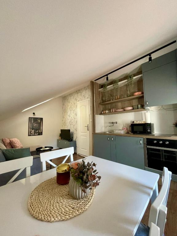 a kitchen with a table with a vase on it at Stari grad 2 in Valjevo