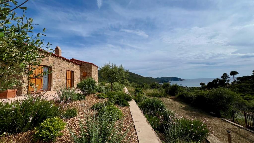 an old house on a hill next to the water at A Casetta d'Armonio in Piana