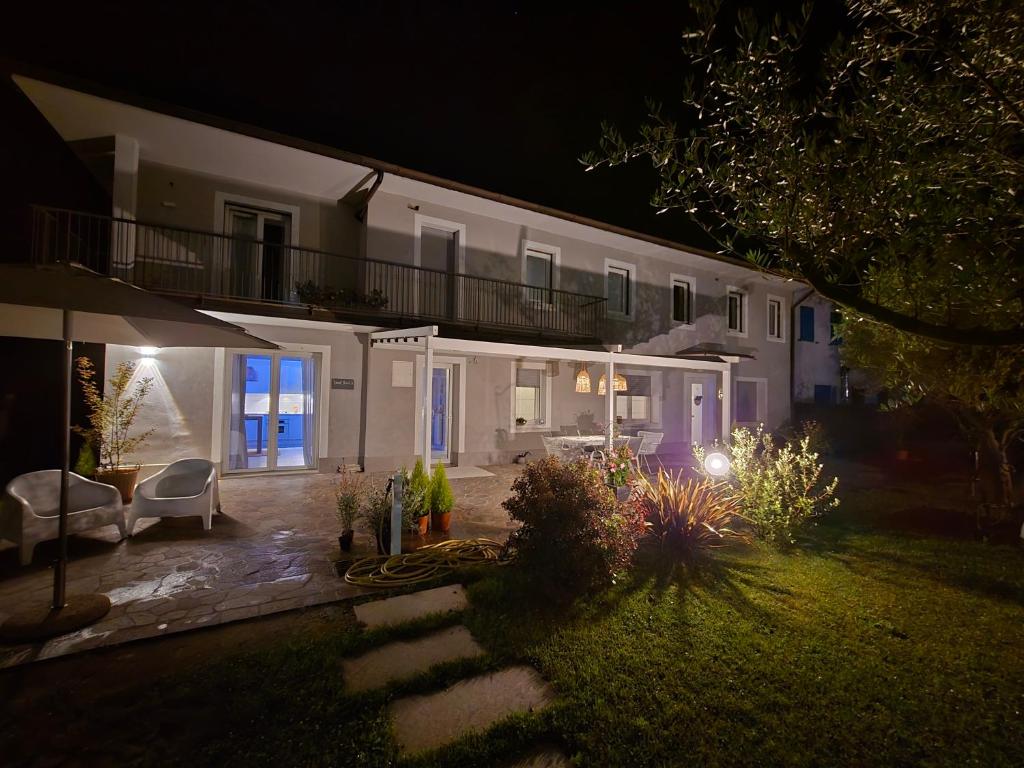 a large white house at night with a yard at Travel Baiot'S in Villanova di Farra