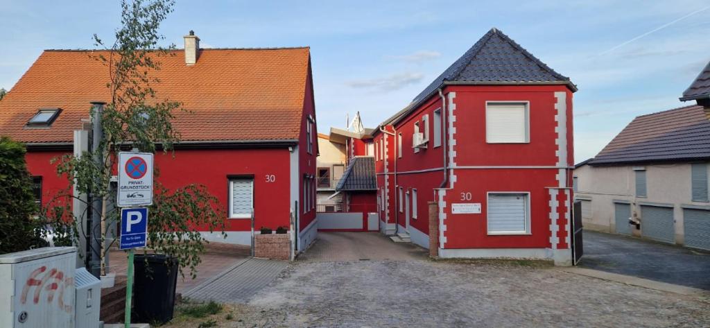 a group of red houses in a street at Ferienapartment Meiss in Erdeborn