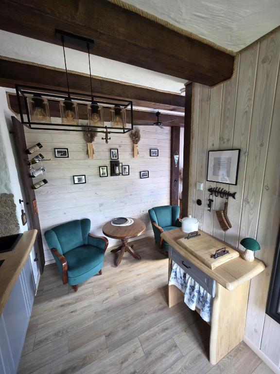 a living room with two chairs and a table at Woodland Apartment Small in Berezka