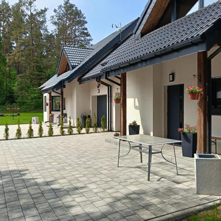 a patio with a table in front of a building at Pokoje Agnieszka in Pollnow