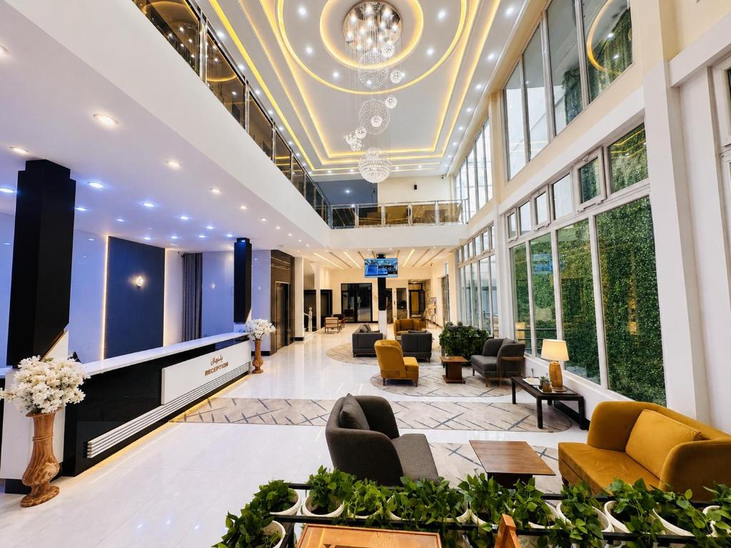 a lobby with couches and chairs in a building at Herat Star Hotel in Herāt