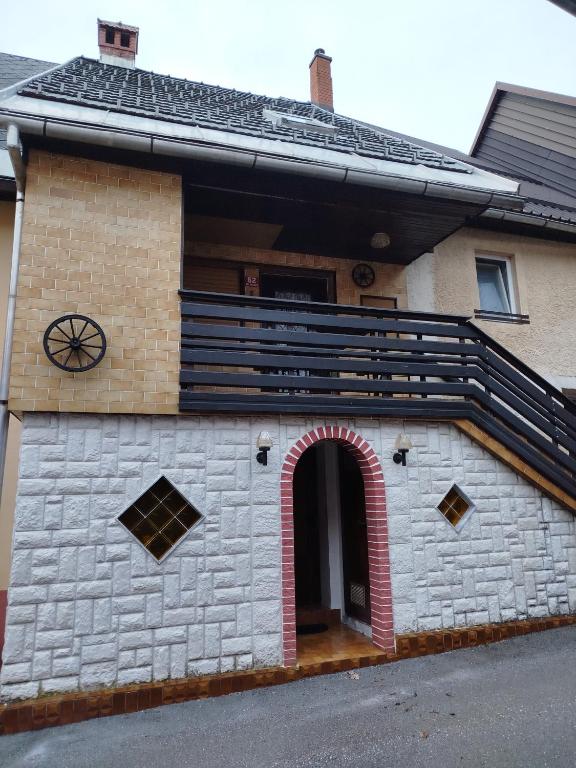 a house with an archway on the side of it at Apartma Silvester in Bovec