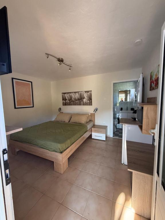 a bedroom with a bed and a desk in it at The Garden Studio AVLI Upper Vrasna in Nea Vrasna