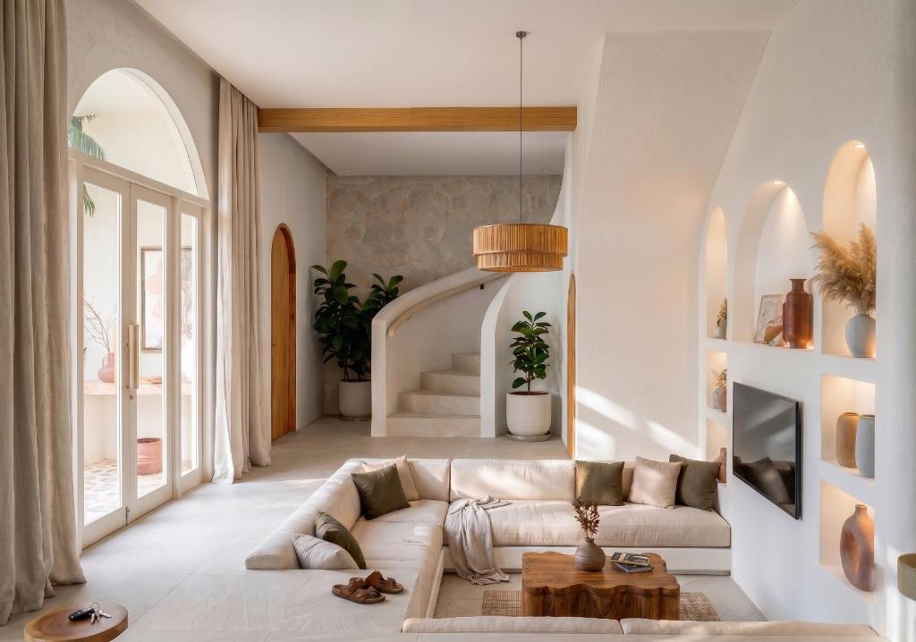 a living room with a couch and a table at Svara Boutique Residences in Uluwatu