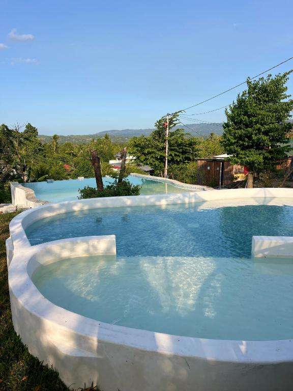 a large swimming pool in the middle of a yard at PAPABO Adventure Village in Moalboal