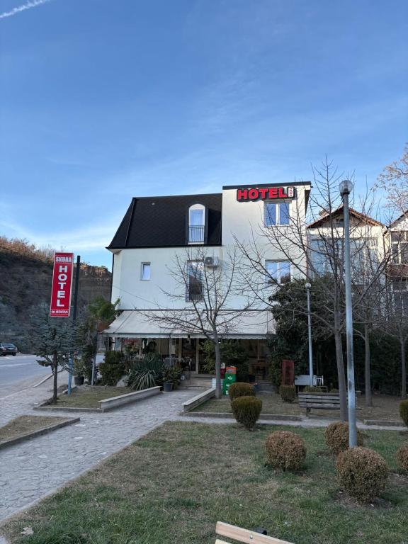 a building with a sign that reads hospital at Hotel SKURA , Librazhd in Librazhd