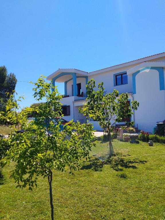 a house with trees in front of it at L' Aurora Marina in SantʼAnna Arresi