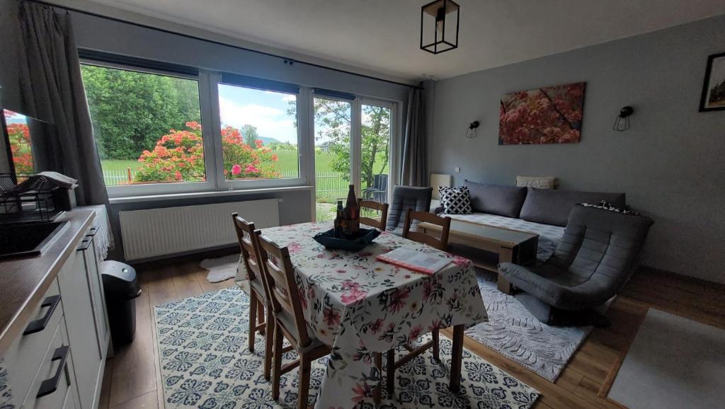 a living room with a table and a couch at Beskydy apartman Four Seasons in Hnojní