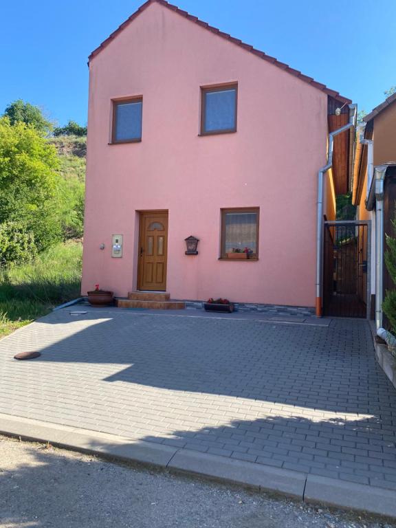 a pink house with a door on a driveway at Rekreační dům Strachotín in Strachotín