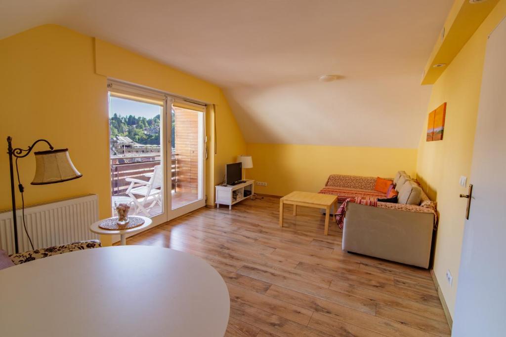 a living room with a couch and a table at B10 Rooms in Baden-Baden