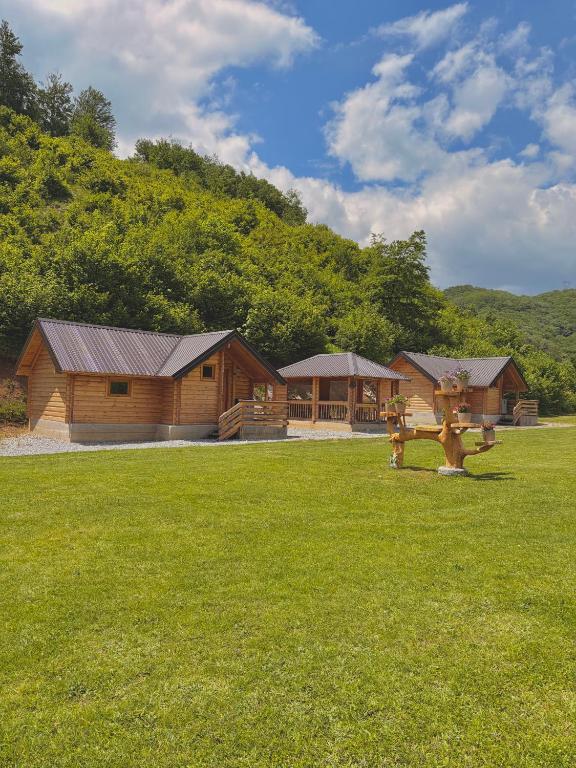a log cabin with a fire hydrant in the grass at Wooden Corner in Kolašin