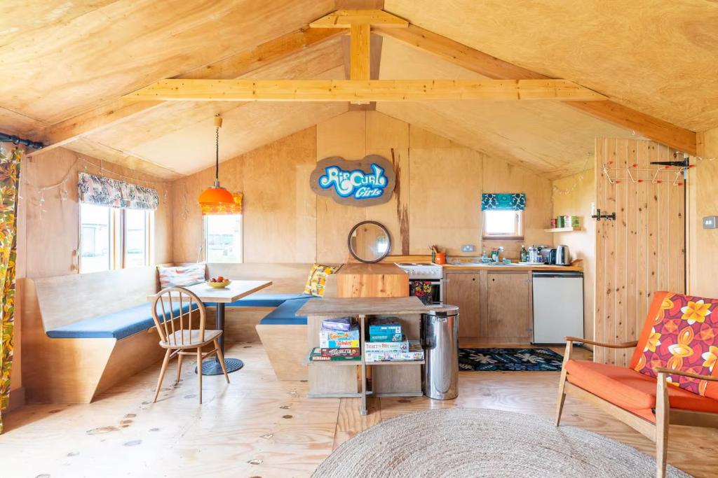 a kitchen with a counter and a table in a room at Bacton Beach Cabin in Bacton