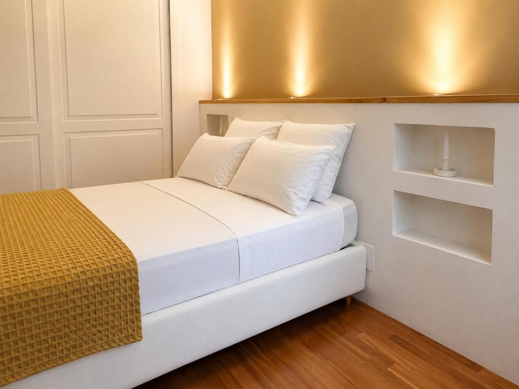 a small bedroom with a white bed with white pillows at Souvenir D Italie in Alatri