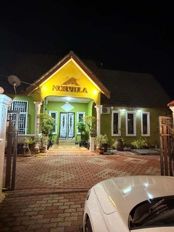 a car parked in front of a building at night at NorvillaA Pantai Cenang in Pantai Cenang