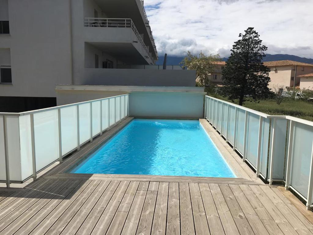 a swimming pool on the balcony of a building at Porto-Vecchio 2-bedroom apartment, pool in Porto-Vecchio