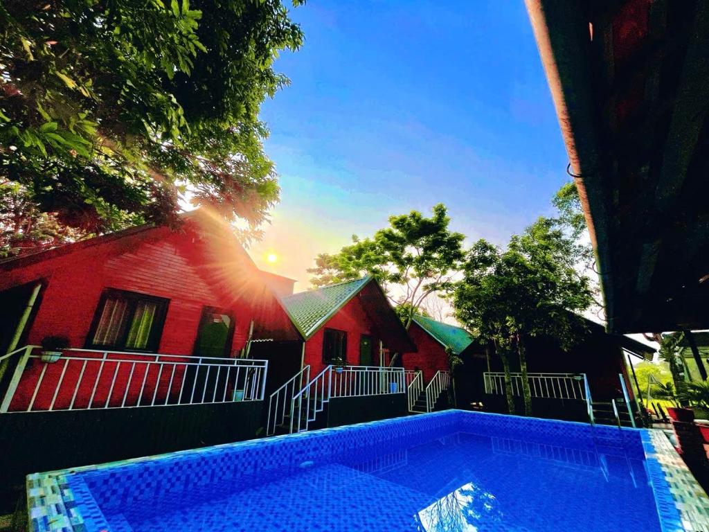 a swimming pool in front of a house at Retreat Bungalow in Phong Nha