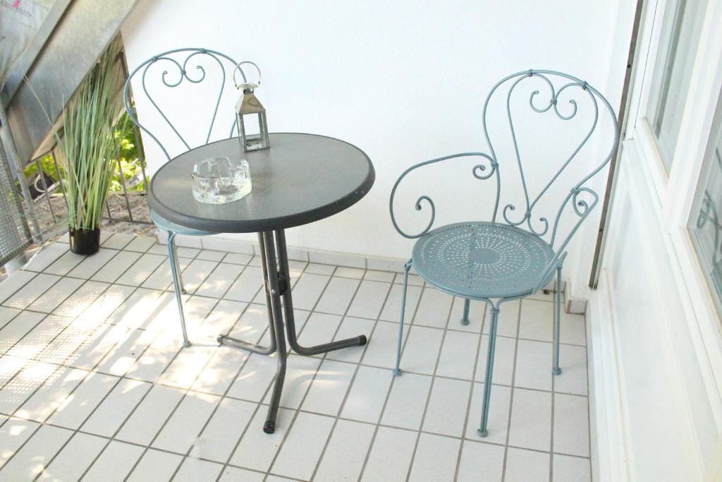 a table and two chairs sitting on a balcony at Harbour Apartment in Moos