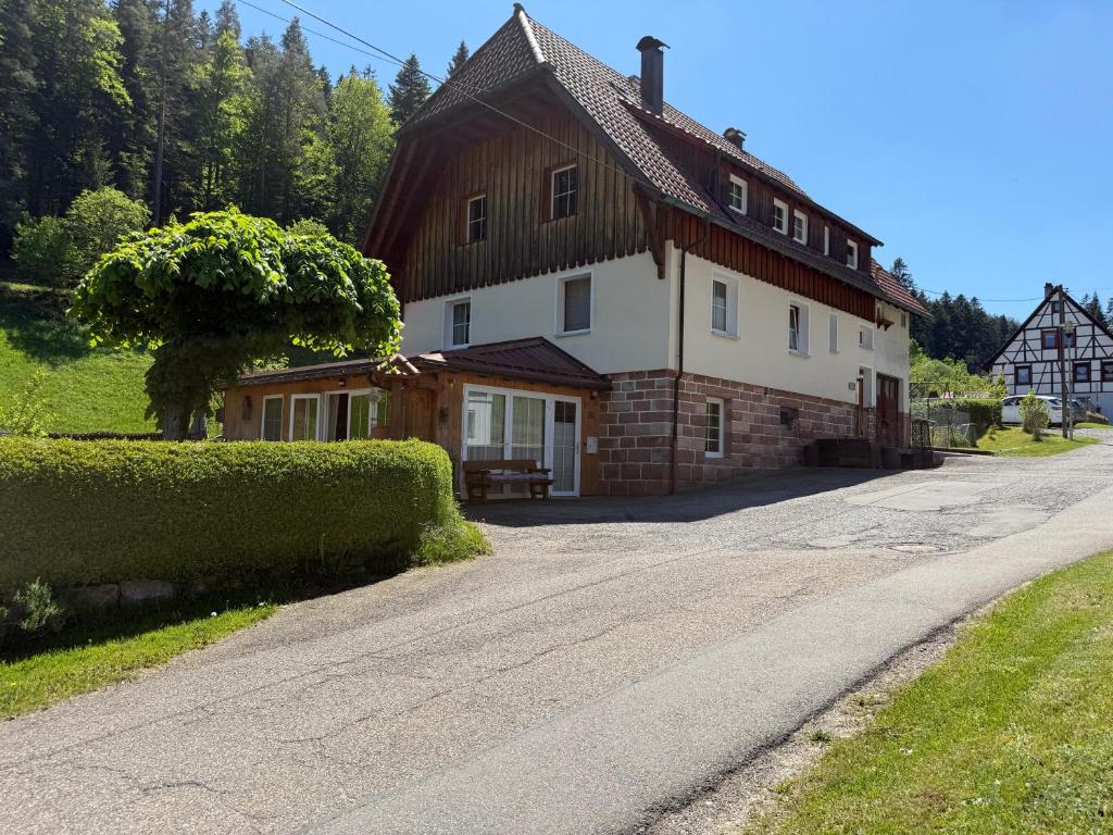 a house on a road in front of a house at Schwarzwaldhaus Zwink Ferienhaus in Enzklösterle