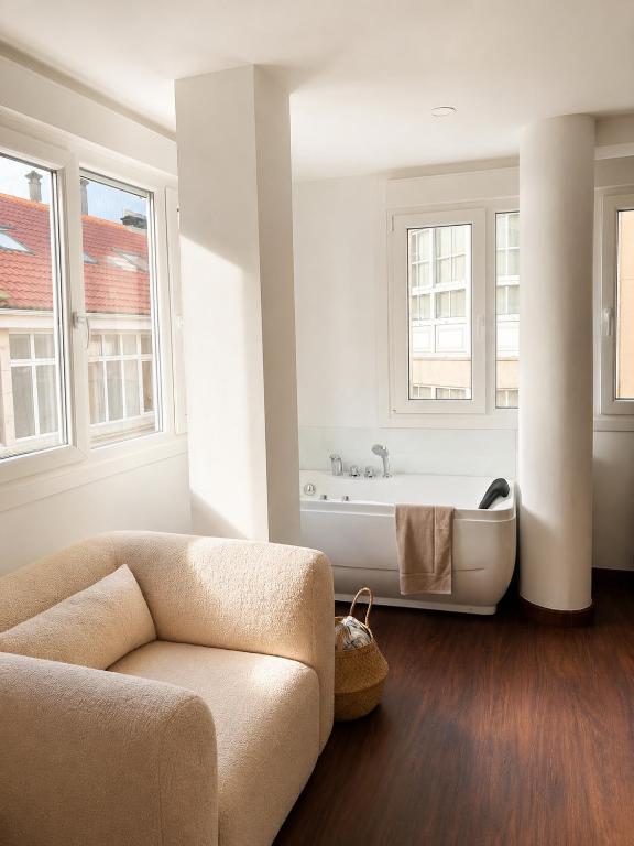 a living room with a couch and a bath tub at Ribeira Penélope in Ribeira