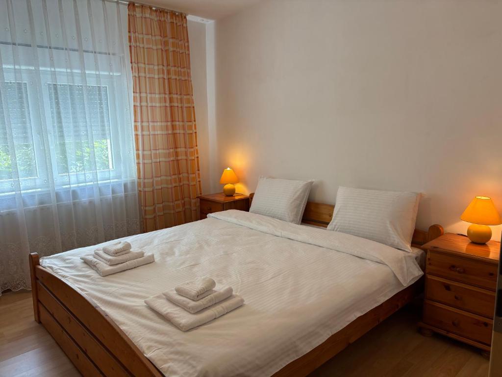 a bedroom with a bed with two towels on it at Sweet Home in Ocna-Mureşului