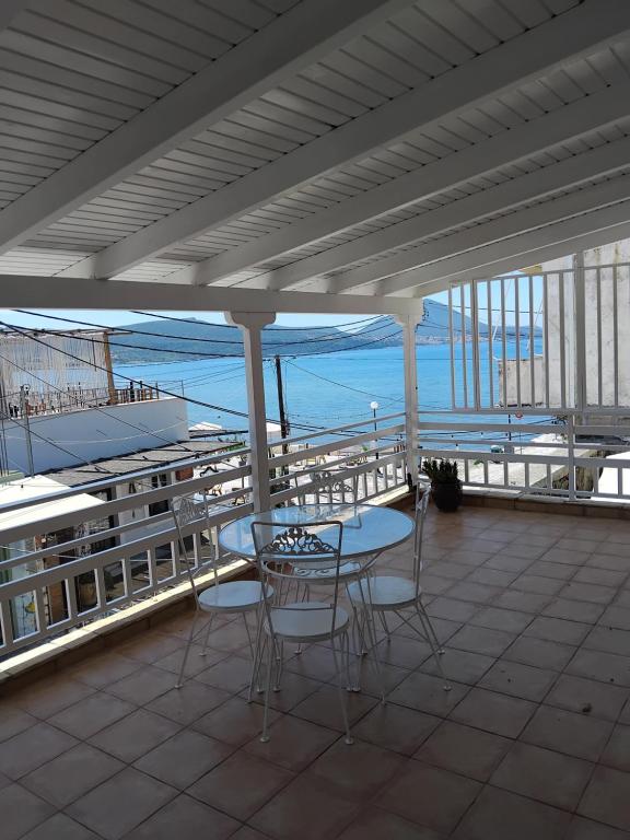 a patio with a table and chairs and the ocean at Sea & Sun in Gialova