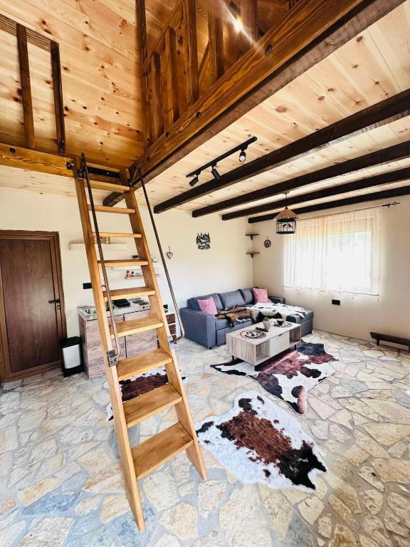 a living room with a ladder and a couch at Falcon Cottage,Montenegro in Korita