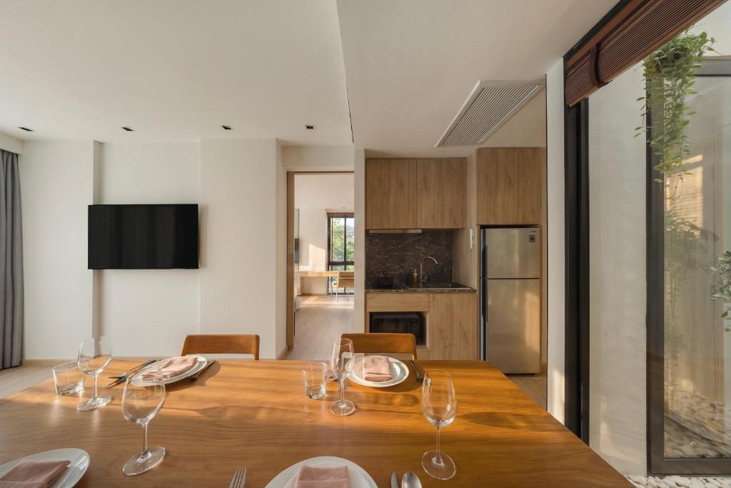 A dining area with a full table setting and a compact kitchen.