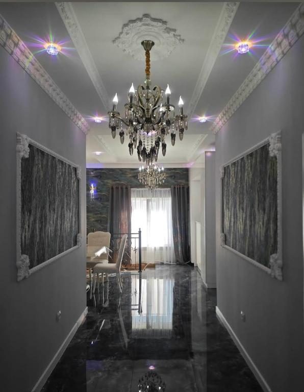 a living room with a chandelier and a dining room at Tyom in Khodzhabegi