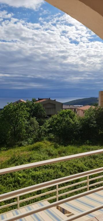 a view of a field with trees and a fence at Emma 2 in Budva