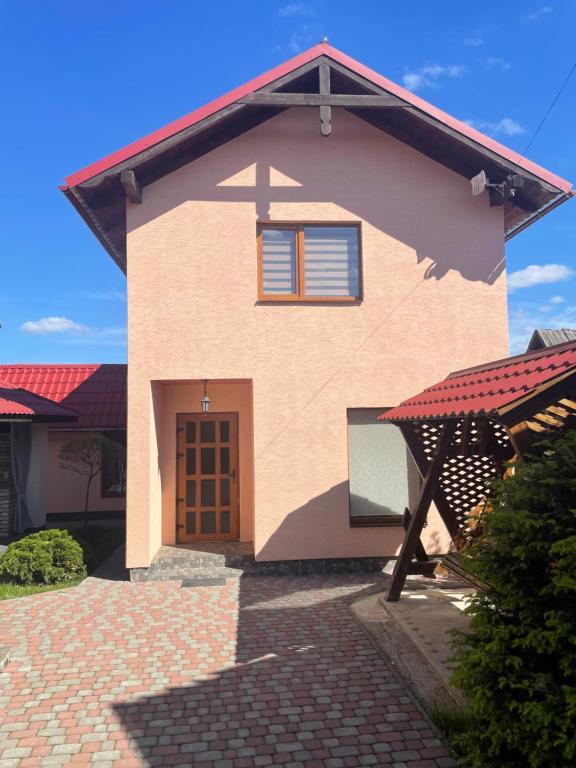 a small house with a red roof at Azaliya in Lazeshchyna