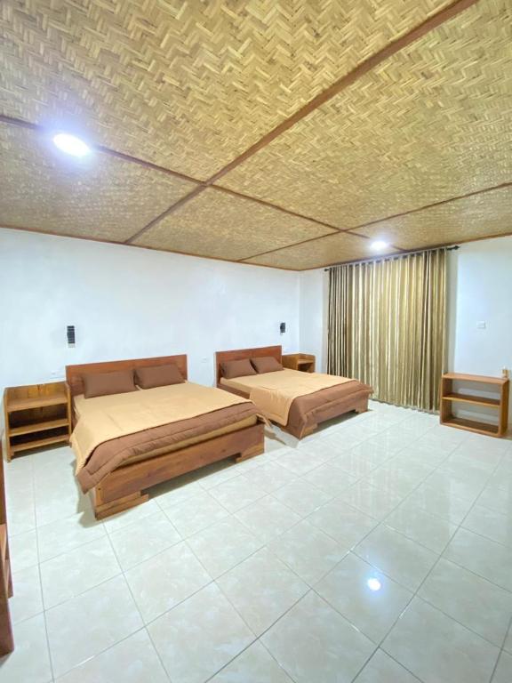 a bedroom with two beds and a ceiling at Nahla bungalows tetebatu in Tetebatu