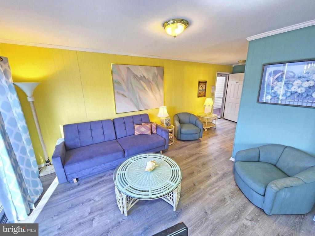 a living room with a couch and chairs and a table at Beach Condo in Ocean City, MD in Ocean City