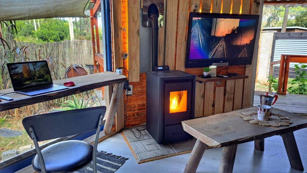 a living room with a wood stove and a tv at SAGRADAS de LA PALOMA in La Paloma