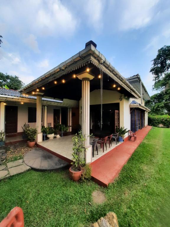 a house with a porch with a patio at Hansika Guest Inn in Buttala