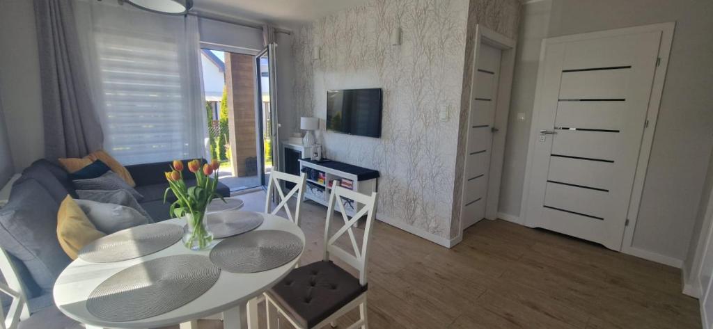 a living room with a table and a couch at Apartament MyMoment in Tupadła