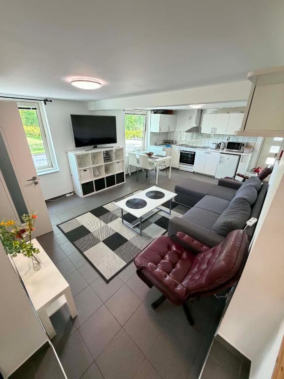 a living room with a couch and a table at Nordic Home Finja in Hässleholm