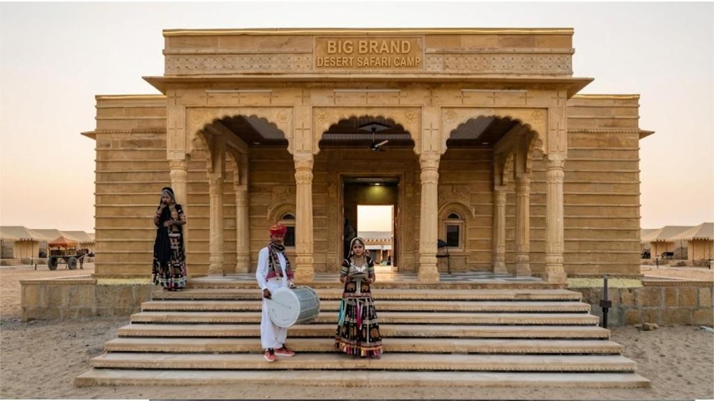 three women standing in front of a building at Big Brand Desert Camp in Jaisalmer