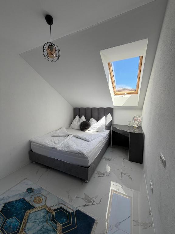 a small bedroom with a bed and a window at SC Apartments Bad Goisern - contactless check in in Bad Goisern